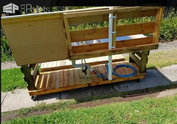 This Pallet Kid's Kitchen has a piece of plumbing that will hold an umbrella.