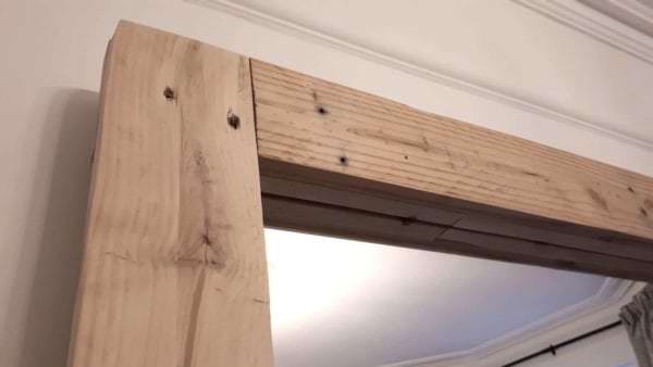 Don't cover up the nail holes on this Simple Pallet Mirror Frame.