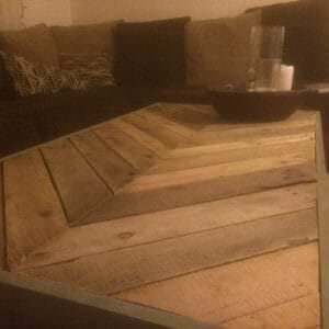 A beautiful reclaimed pallet wood table built in a chevron pattern