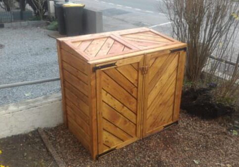Here is the final project - my pallet trash bin shed in place, with 3 coats of varnish. It looks great, and it will not be long before the neighbors have bin envy.