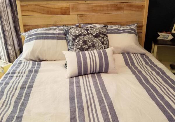 Just look at that wood grain! This clean design features the beautiful texture and uniqueness of pallet wood to create a centerpiece in your bedroom!